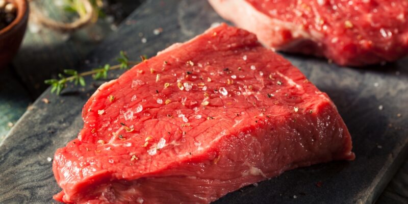 A picture of a grass-fed beef steak being prepared for cooking.