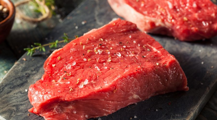A picture of a grass-fed beef steak being prepared for cooking.